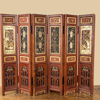 A Chinese six-panel screen in painted, gilt and reticulated wood, 19th C.
