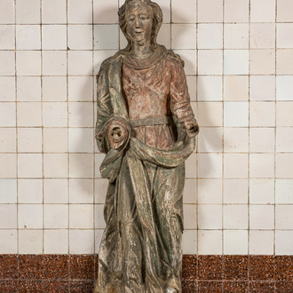 A large polychrome wooden sculpture of a female saint, early 17th C.