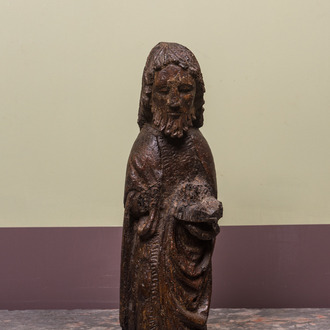 A Spanish walnut figure of John the Baptist, mid 15th C.