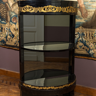 A gilt copper-mounted ebonised demi-lune bar cabinet with mirror back, 19th C.