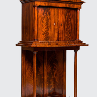 A neoclassical mahogany cabinet on stand, 19th C.