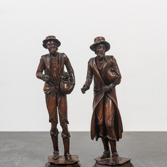 Two 'Black Forest' linden wooden sculptures of beggars, 19th C.