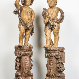A pair of large polychrome wooden allegorical putti on bases, probably Italy, 18th C.