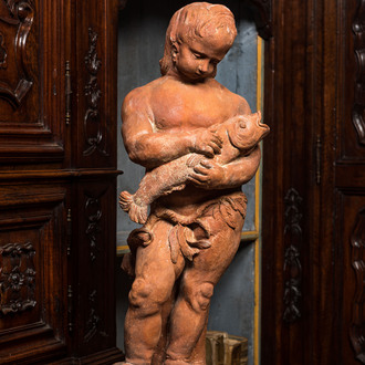 A terracotta figure of a boy holding a fish, 19th C.