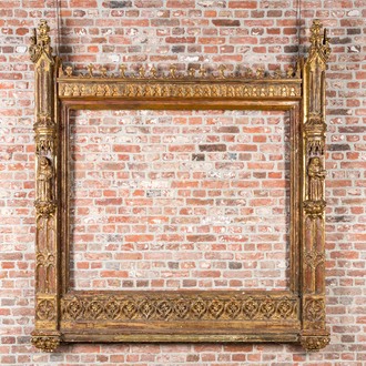An impressive Gothic Revival carved and gilt wood frame with monks under canopies, 19th C.