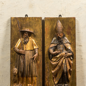 A pair of polychrome wooden reliefs with Saint Anthony and a bishop, 17th C.