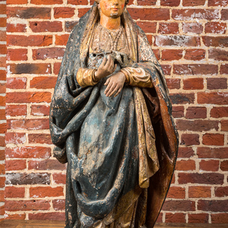 A large polychrome wooden sculpture of a female saint, ca. 1600