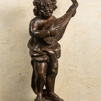 A large patinated wooden putto playing the lute, 18th C.
