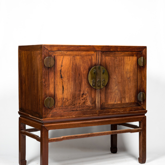 A Chinese hardwooden brass mounted two-door cabinet on foot, 20th C.