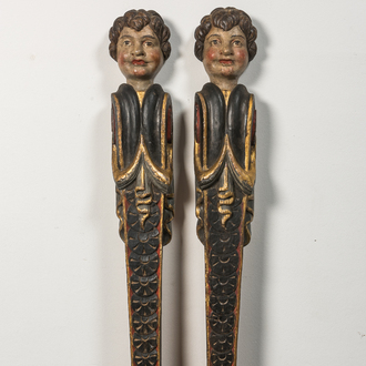 A pair of polychrome wooden pillars or atlants with boys' heads, 19th C.