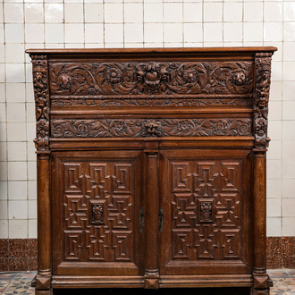 A Flemish oak 'columns' cupboard, 17th C. with later elements
