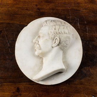 An English white marble medallion depicting the profile portrait of John Peyto Charles Shrubb, dated 1886