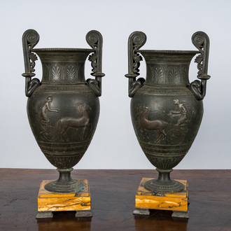 A pair of neoclassical style vases with charioteers on a Siena marble base, 19/20th C.