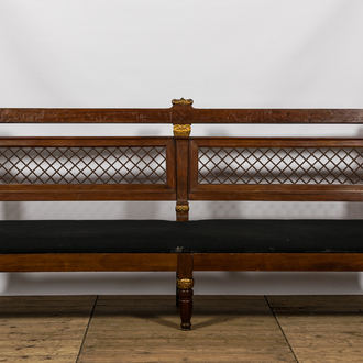 A lavish partly gilt upholstered mahogany bench, probably France, 19th C.