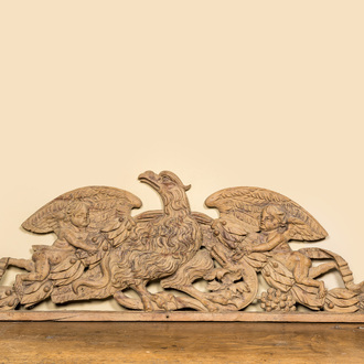 A large leached oak relief depicting an eagle slaying a serpent and two angels, 18th C.