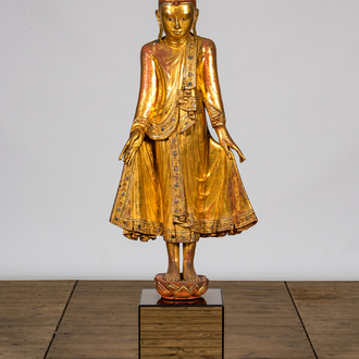 A tall inlaid gilt wooden figure of a standing Buddha, Thailand, 20th C.