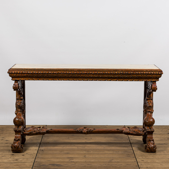 A richly carved wooden wall console with marble top, 19th C.