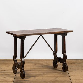 A Spanish walnut table with wrought iron connection, 19th C.