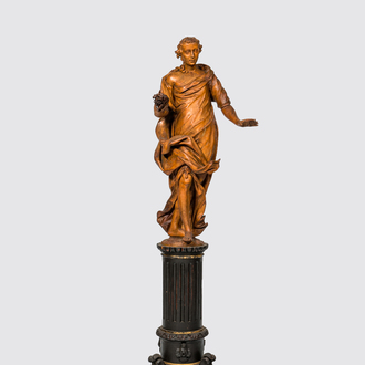 A basswooden allegorical 'Spring' figure on an ebonised neoclassical wooden base, 18/19th C.