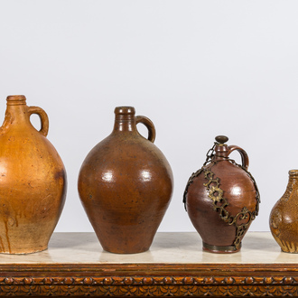 Four various stoneware jugs, incl. two bellarmine jugs and one with a gilt bronze chain mount, Raeren and Frechen, 17th C.