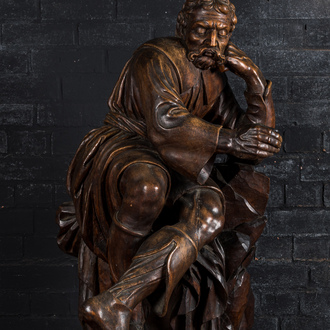 A large walnut sculpture of a resting man, 18/19th C.