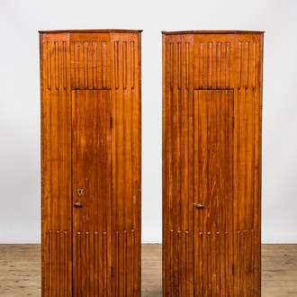 A pair of fluted wooden corner cabinets, 19/20th C.