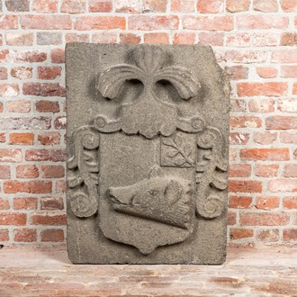 A carved stone relief with a coat of arms with the head of a wild boar, 19th C.