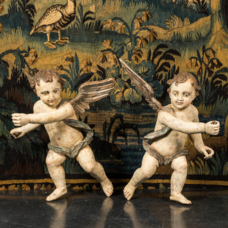 A pair of large polychrome wooden winged cherubs, 19th C.