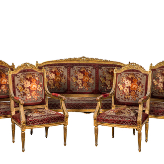 A neoclassical gilt wooden salon set comprising a sofa and four armchairs, 20th C.