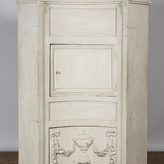 A neoclassical whitewashed corner cabinet, 19th C.