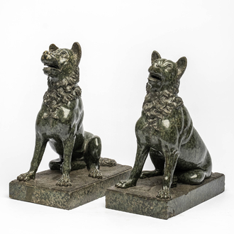 A pair of green porphyry sculptures of seated dogs, 1st half 20th C.