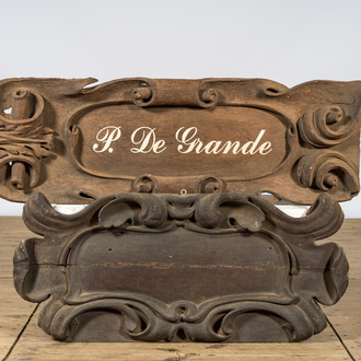 A pair of wooden signboards of which one bearing the name P. De Grande, 20th C.