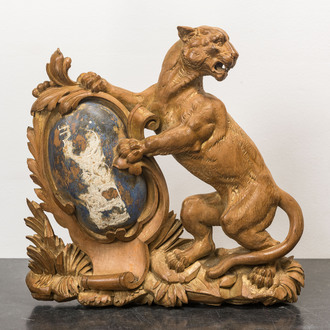A wooden relief with a tiger holding a shield, 19th C.