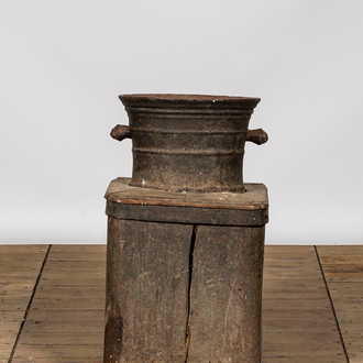 A large iron mortar on wooden stand, 17th C.