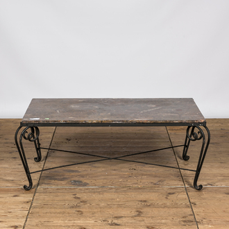 A wrought iron coffee table with marble top, 20th C.