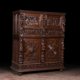 A Flemish richly carved oak 'beeldenkast' or cupboard, 17th C.