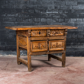 A Spanish carved wooden table with four drawers, 17th C. and/or later