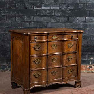 A French Louis XV-style oak commode on lion paw stands, 19th C.