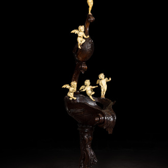 A richly carved walnut jardinière or stand with angels, 19th C.