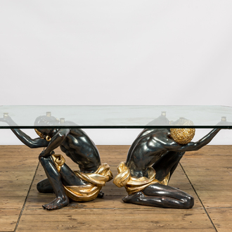 A coffee table with a glass top resting on two polyester Moorish figures, Italy, 2nd half 20th C.
