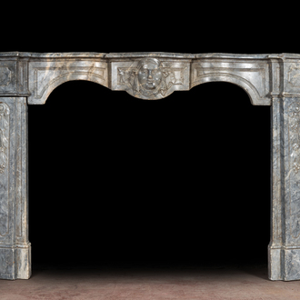 A French Louis XV-style gray marble fireplace with mascaron, 19th C.
