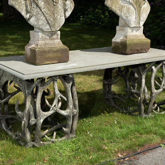 An impressive exterior table with bluestone top on entwined polyester antlers, 20th C.