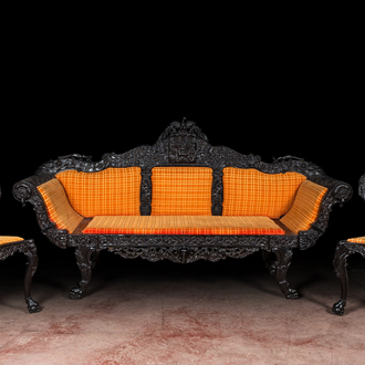 An Anglo-Indian colonial carved wooden sofa with two matching chairs, late 19th C.