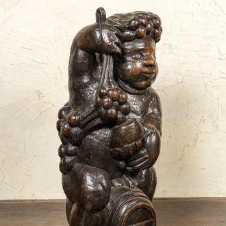 A carved walnut figure of Bacchus on a barrel, 18/19th C.