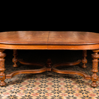 A large oval wooden table on carved baluster-shaped legs, early 20th C.