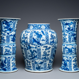 A large Chinese blue and white garniture of three vases, Kangxi