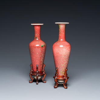 A pair of Chinese peachbloom-glazed vases on wooden stands, Kangxi mark, 19th C.