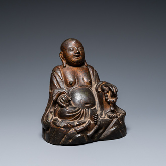 A Chinese gilt bronze figure of Buddha seated on a rock, Ming