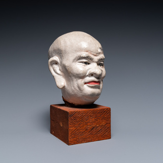 A Chinese painted stucco head of a Luohan, probably Jin or Yuan, 12/14th C.