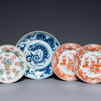 A Chinese blue and white 'dragon' dish and three iron-red and famille rose plates, 18th C.